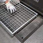 The scraper grate collects dirt in front of the machine